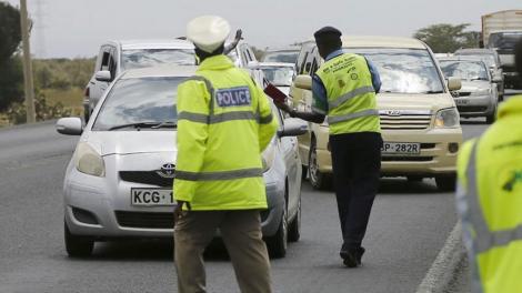 Traffic police officers stop motorist at a checkpoint. On Wednesday, May 13, 2020, NTSA issued a warning to motorists.